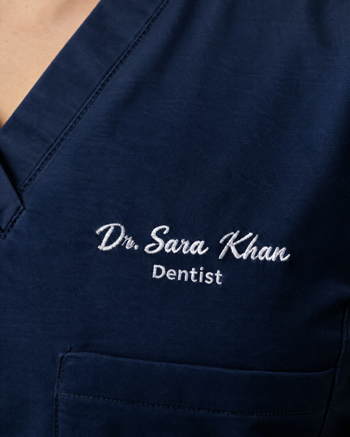 Custom name embroidery on a navy scrub top